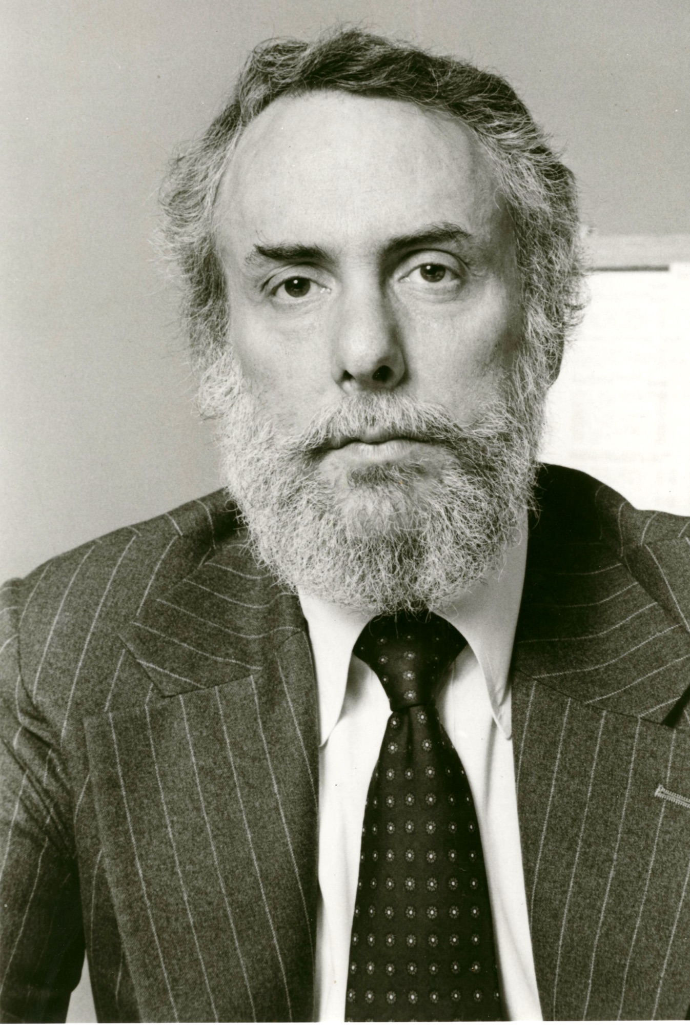 A black-and-white portrait of Marshall with a beard
