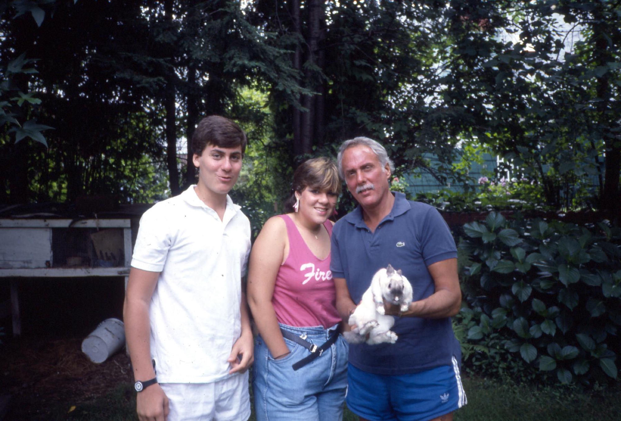 Marshall with family and a rabbit in the backyard