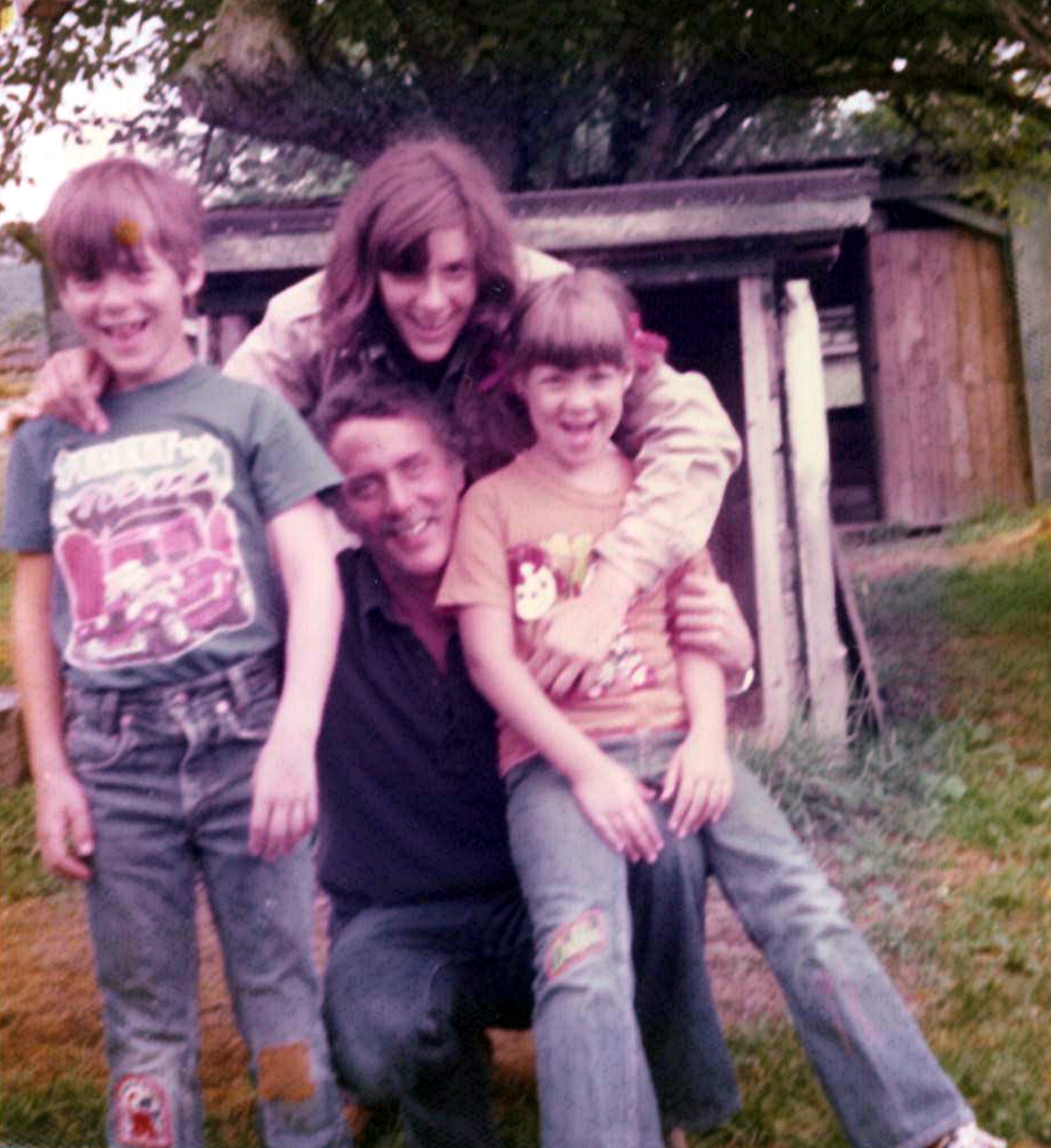 Marshall sharing a playful outdoor moment with his children