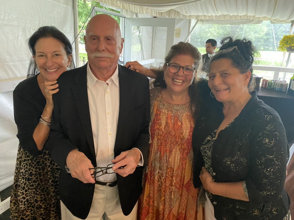 Marshall surrounded by smiling friends at a family celebration