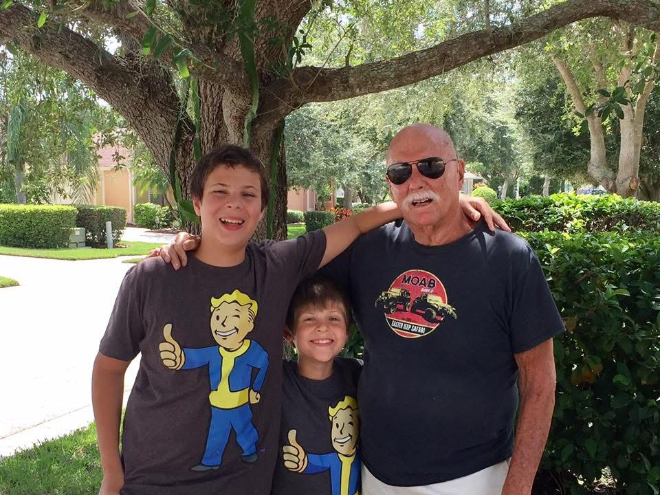 Marshall outdoors with two of his grandsons